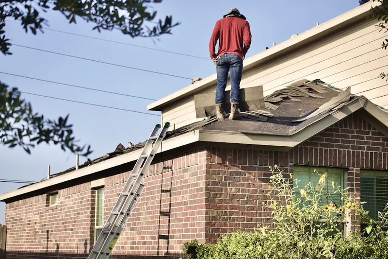 Professional roofer working on a residential roof in El Rio